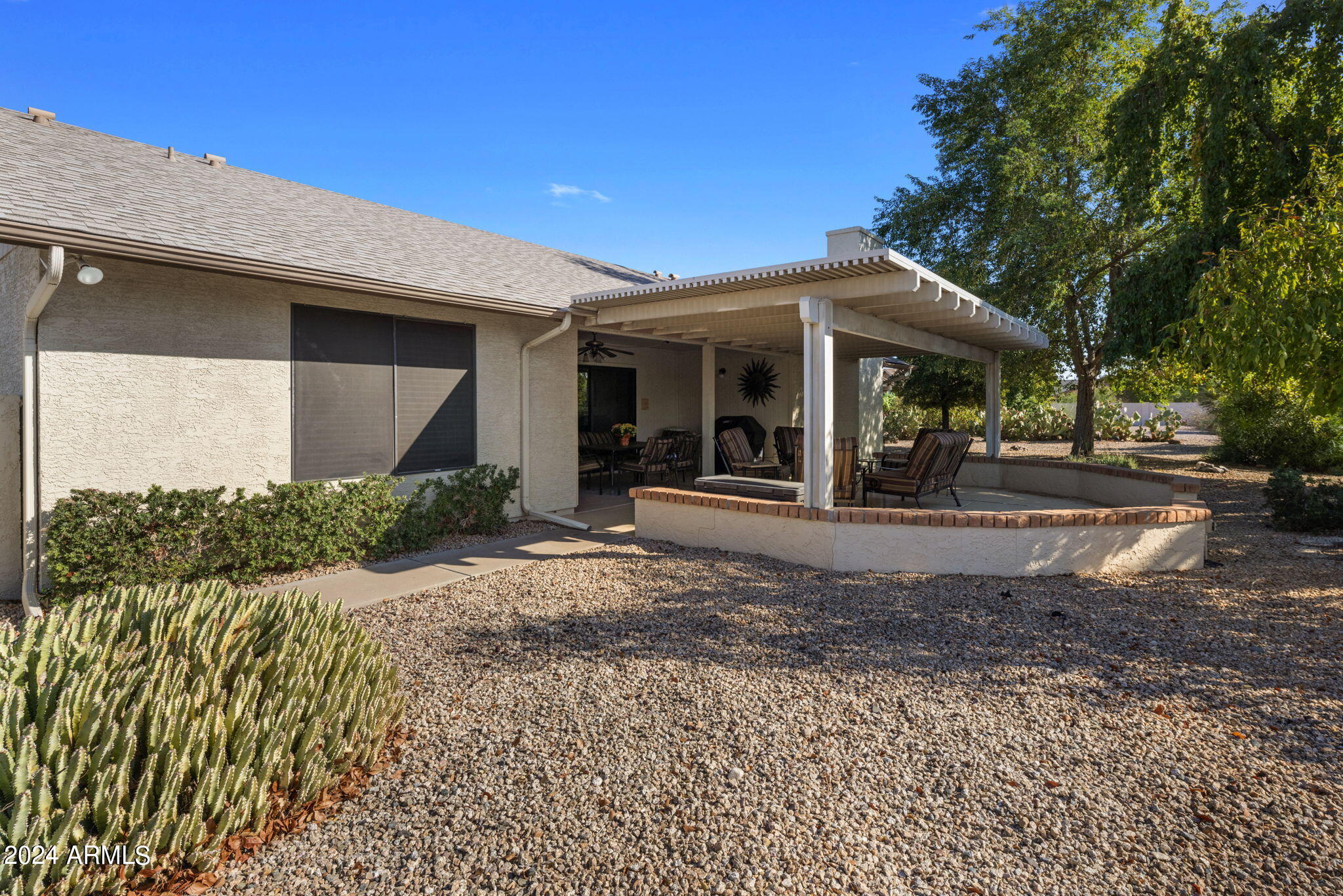 9856 West Rimrock Drive Peoria, AZ 85382 - Photo 11 of 37 a view of a porch with a table and chairs under an umbrella