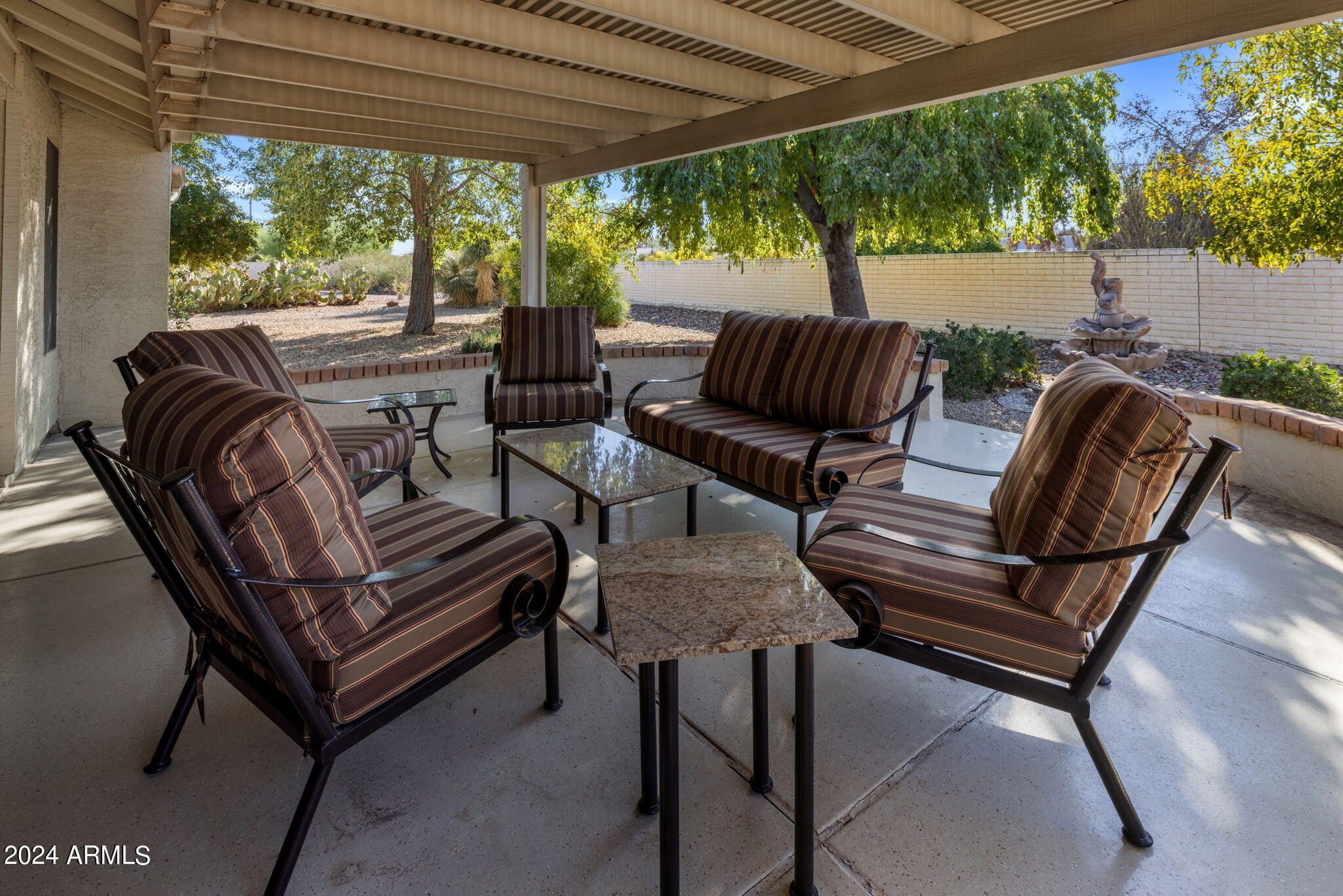 9856 West Rimrock Drive Peoria, AZ 85382 - Photo 13 of 37 a view of a patio with chairs and a table