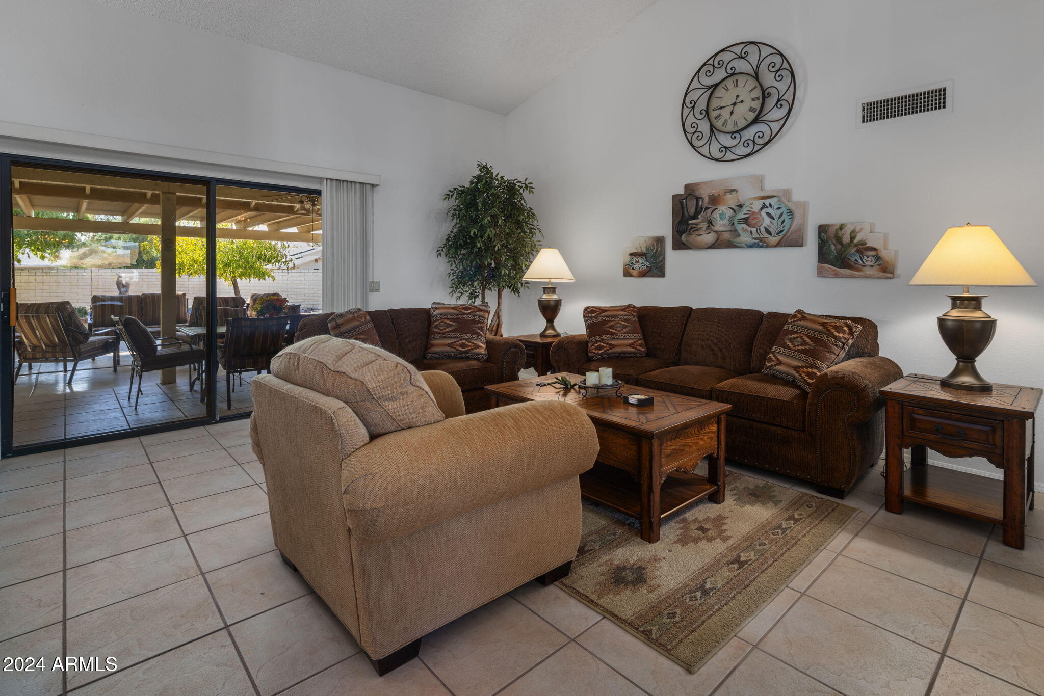 9856 West Rimrock Drive Peoria, AZ 85382 - Photo 18 of 37 a living room with furniture a window and a clock