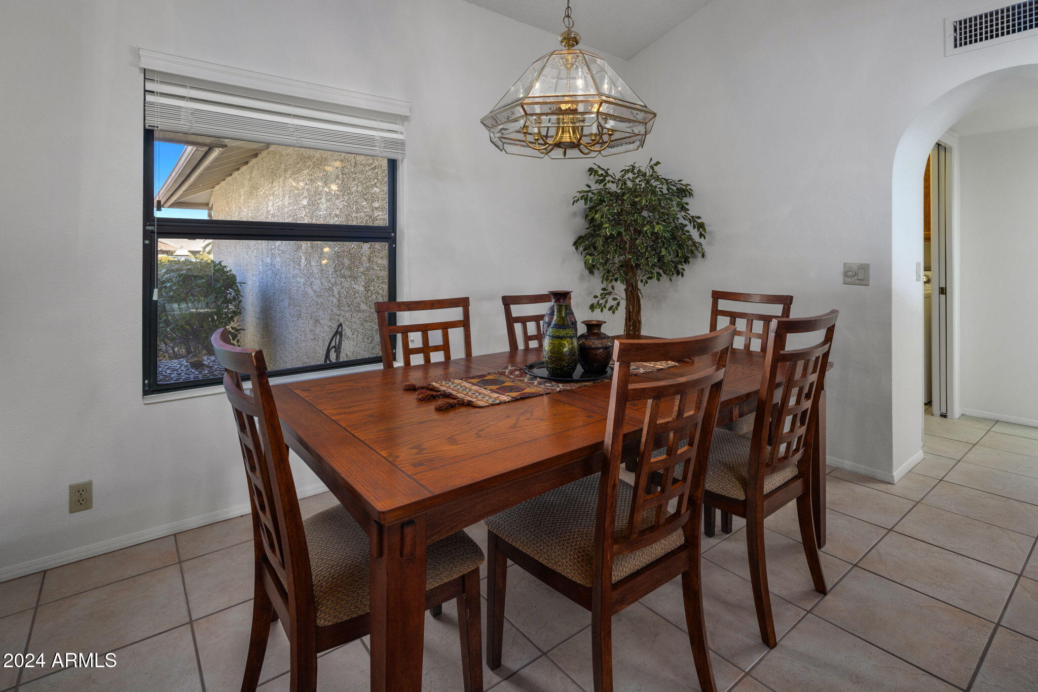 9856 West Rimrock Drive Peoria, AZ 85382 - Photo 19 of 37 a view of a dining room with furniture and chandelier