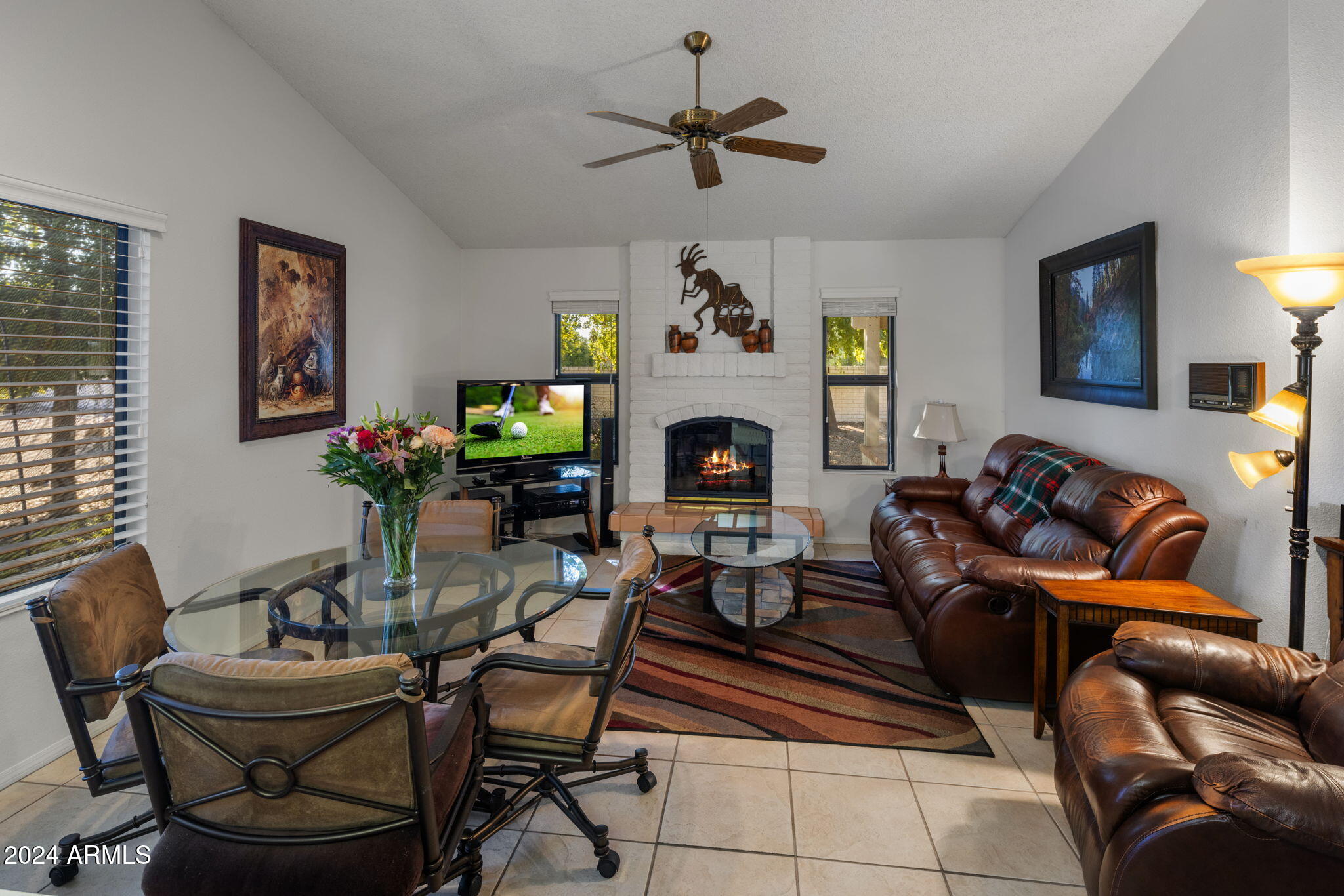 9856 West Rimrock Drive Peoria, AZ 85382 - Photo 21 of 37 a living room with furniture a fireplace and a window