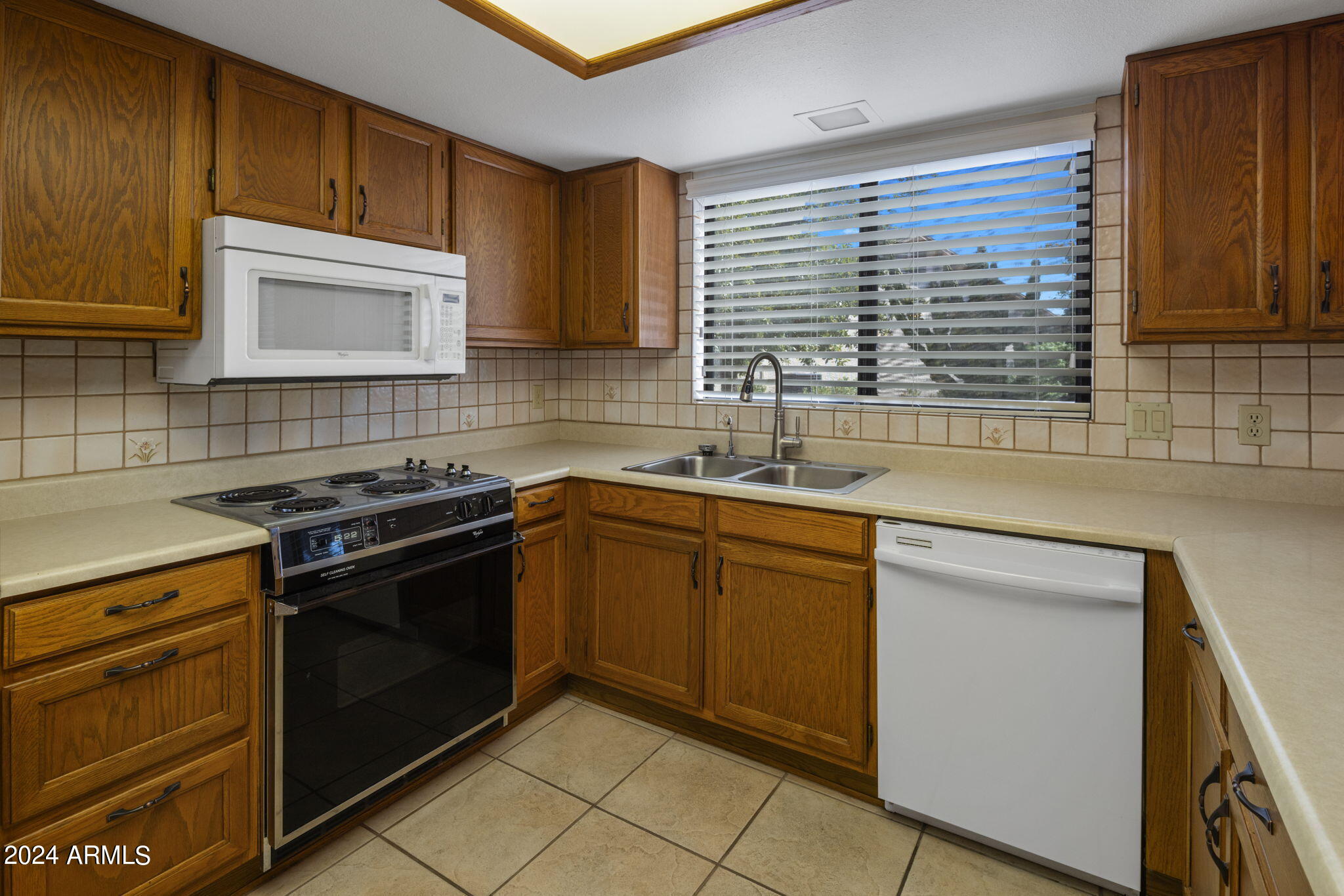 9856 West Rimrock Drive Peoria, AZ 85382 - Photo 23 of 37 a kitchen with a sink stove and cabinets