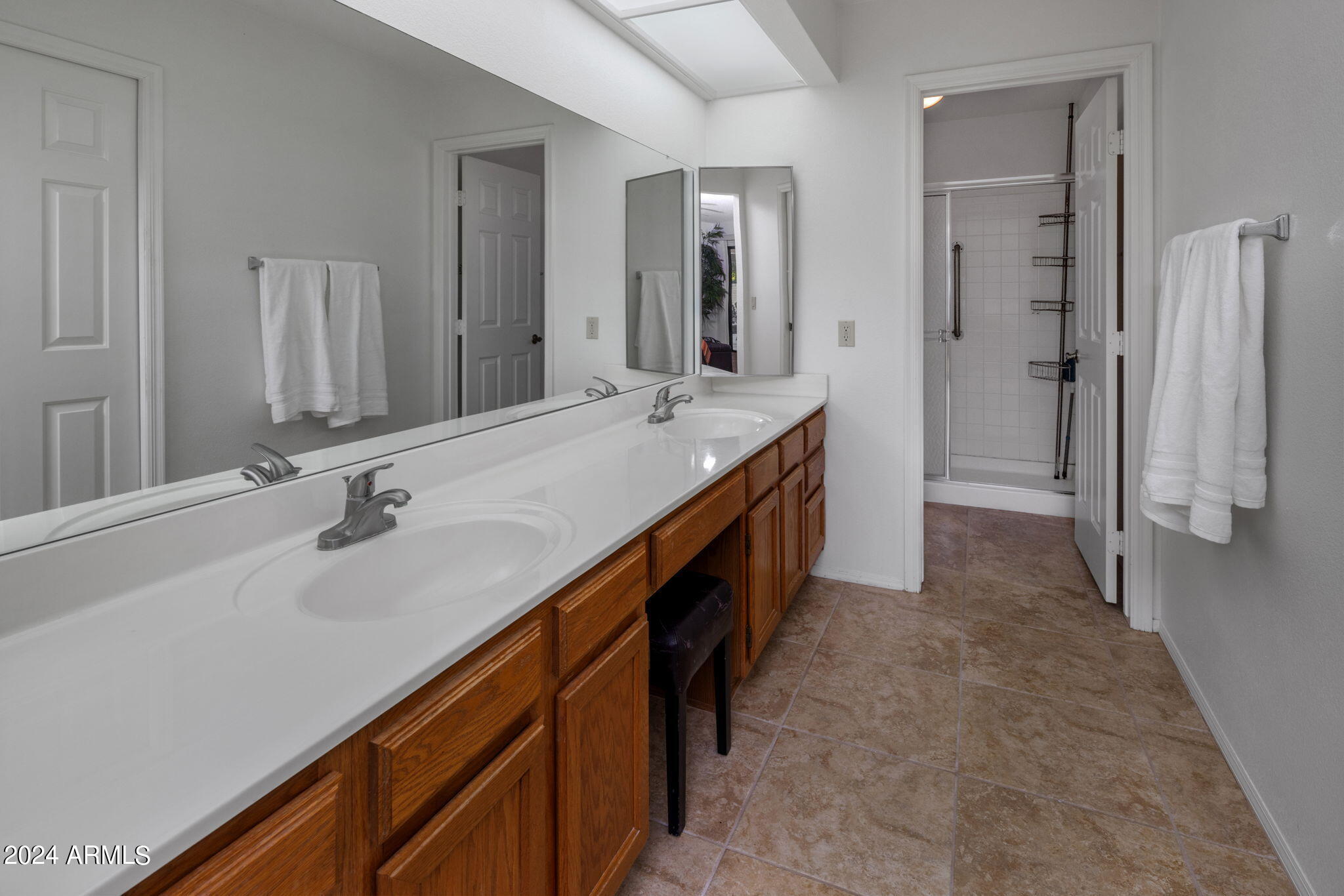 9856 West Rimrock Drive Peoria, AZ 85382 - Photo 29 of 37 a spacious bathroom with double vanity and a mirror