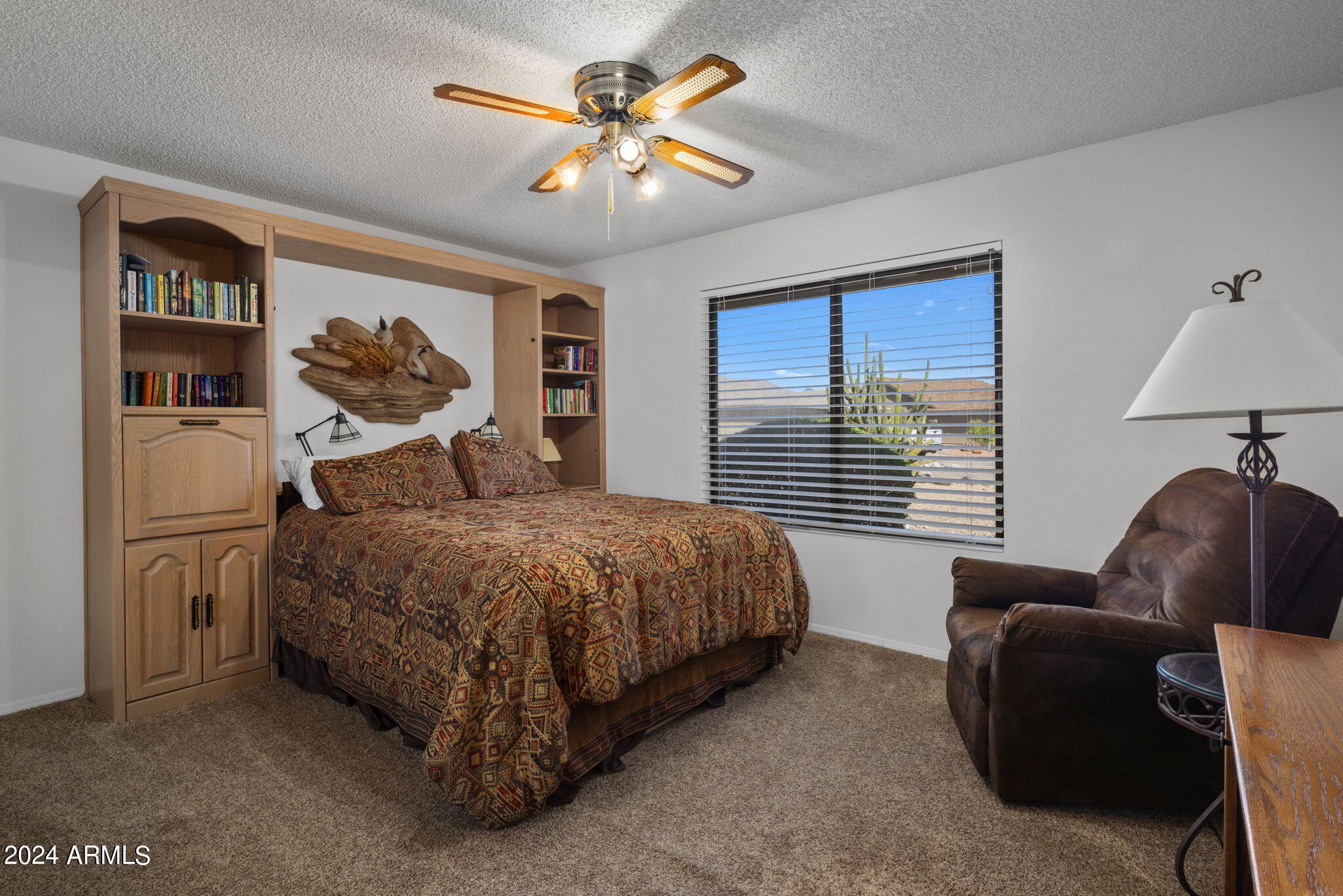 9856 West Rimrock Drive Peoria, AZ 85382 - Photo 31 of 37 a bedroom with a bed couch and window