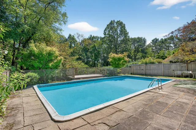 a view of a house with swimming pool and sitting area