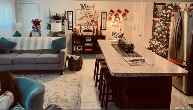 a living room with furniture a rug and a window