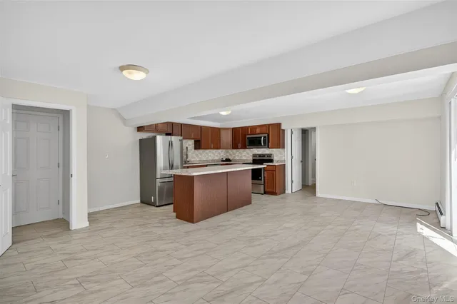 a kitchen with stainless steel appliances a refrigerator and a stove top oven