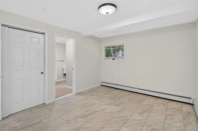 an empty room with a empty space and window