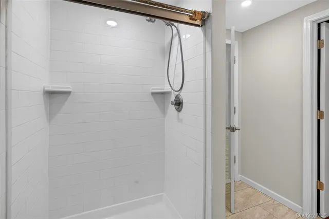 a bathroom with a glass shower door