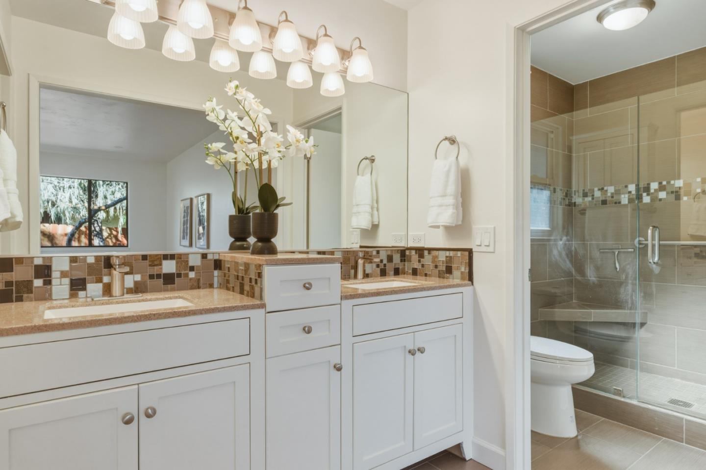 1171 Chaparral Road Pebble Beach, CA 93953 - Photo 16 of 20 a bathroom with a sink a toilet and a shower