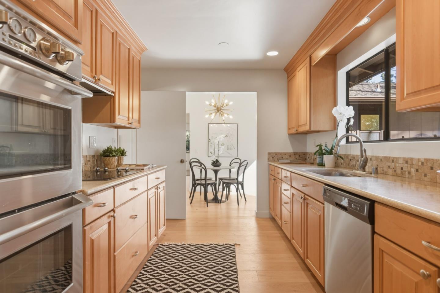 1171 Chaparral Road Pebble Beach, CA 93953 - Photo 9 of 20 a kitchen with granite countertop a sink stove and cabinets