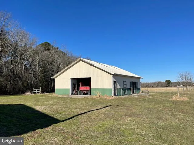 a car parked in front of a house with a big yard
