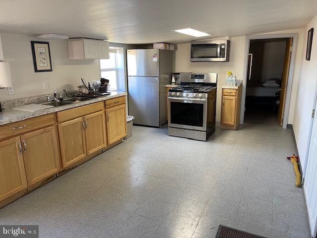6794 Bent Pine Road Willards, MD 21874 - Photo 18 of 29 a kitchen with stainless steel appliances granite countertop a stove a sink and a refrigerator