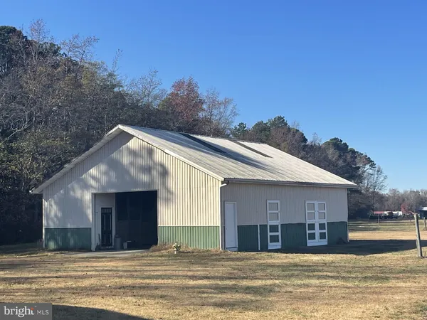 a view of a house with a swimming pool and sitting area