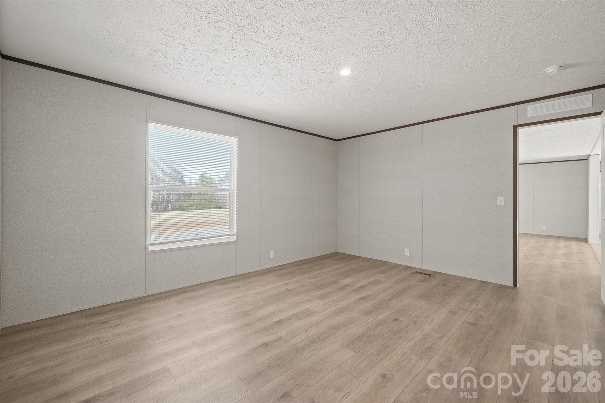 3613 Jamestown Road Morganton, NC 28655 - Photo 21 of 30 an empty room with wooden floor and windows