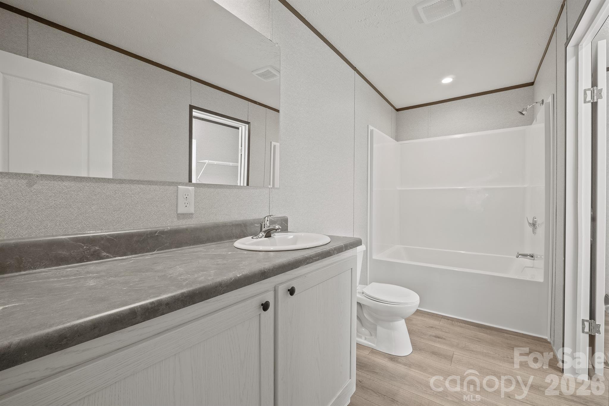 3613 Jamestown Road Morganton, NC 28655 - Photo 24 of 30 a bathroom with a granite countertop sink a toilet and shower