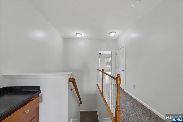 a view of a hallway with stairs