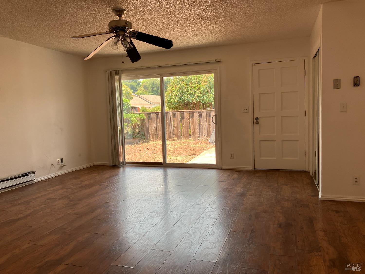 Sereno Drive Vallejo, CA 94589 - Photo 7 of 20 a view of room with hardwood floor and ceiling fan
