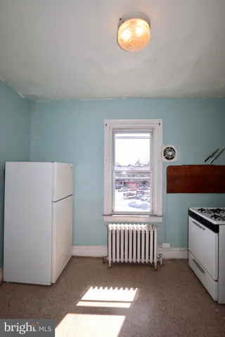 a kitchen with granite countertop cabinets stainless steel appliances and a window