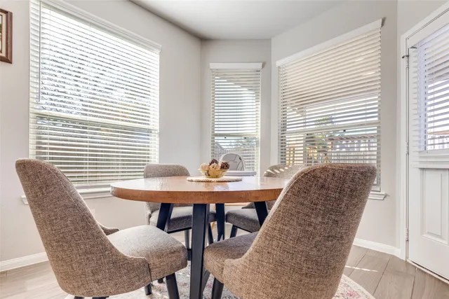 a view of a dining room with furniture and window