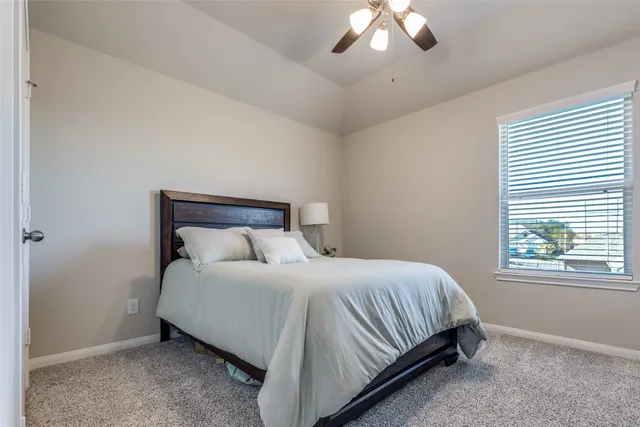 a bedroom with a bed and window
