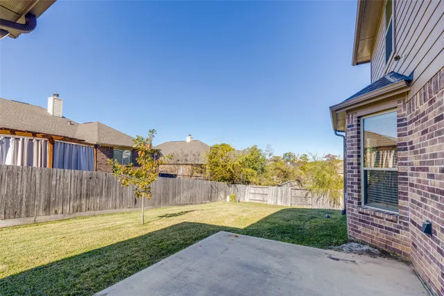 a view of a house with a yard and a fountain
