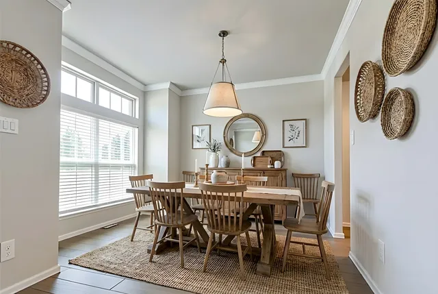 a view of a dining room with furniture window and wooden floor