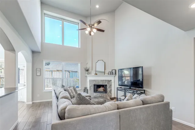 a living room with furniture a fireplace and a flat screen tv