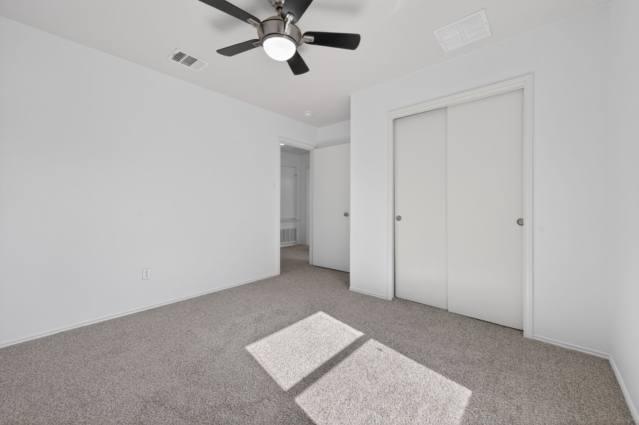 13629 Coomer Path Pflugerville, TX 78660 - Photo 21 of 30 Unfurnished bedroom with a closet, carpet flooring, and ceiling fan