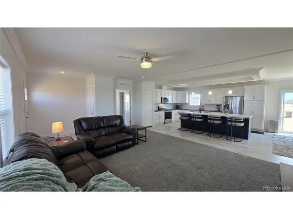 a living room with furniture and a lamp