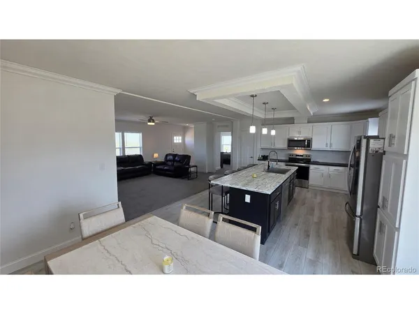 a kitchen with a sink refrigerator and a counter top space