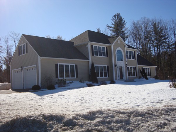 12 Carlson's Way Rutland, MA 01543 - Photo 3 of 30 a front view of a house with a yard covered in snow