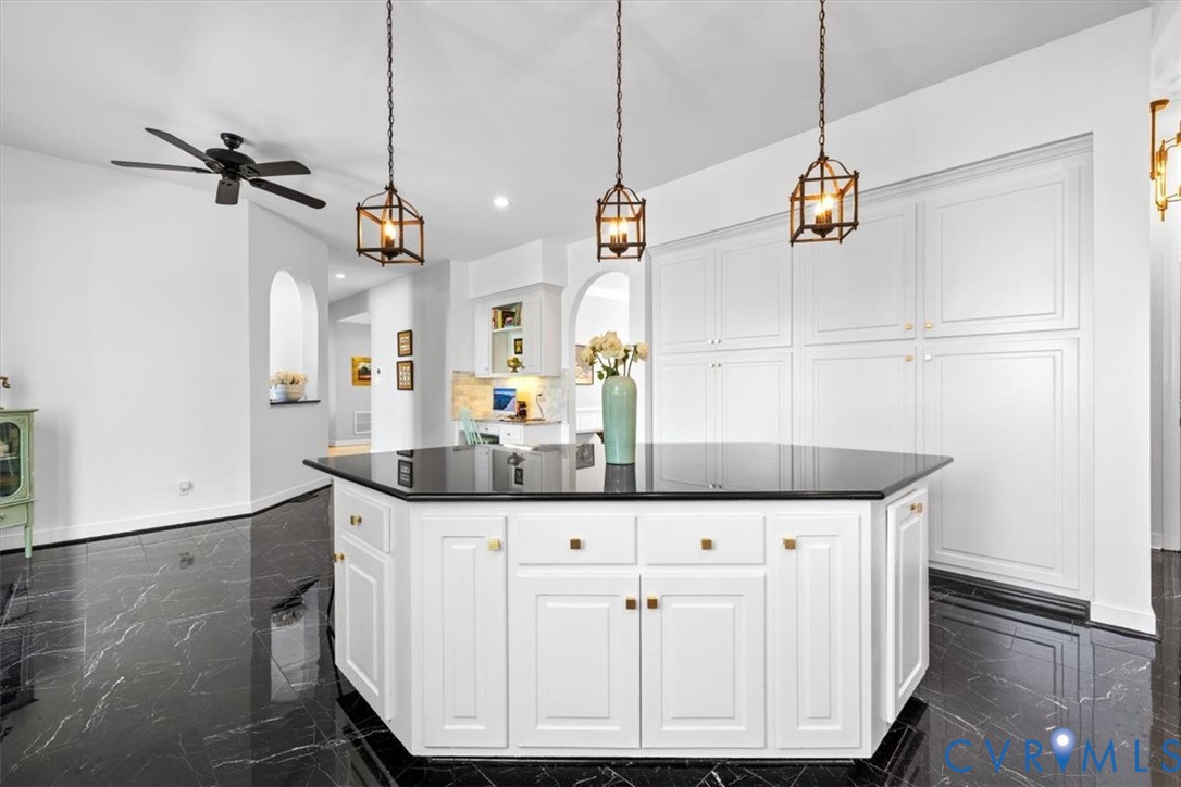 402 Rivers Bend Circle Chester, VA 23836 - Photo 25 of 80 a kitchen with kitchen island white cabinets and white appliances