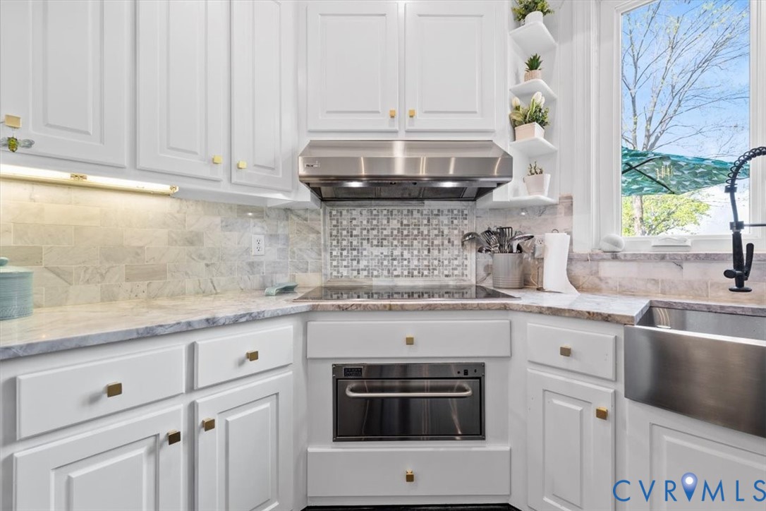402 Rivers Bend Circle Chester, VA 23836 - Photo 26 of 80 a kitchen with granite countertop white cabinets and white stainless steel appliances