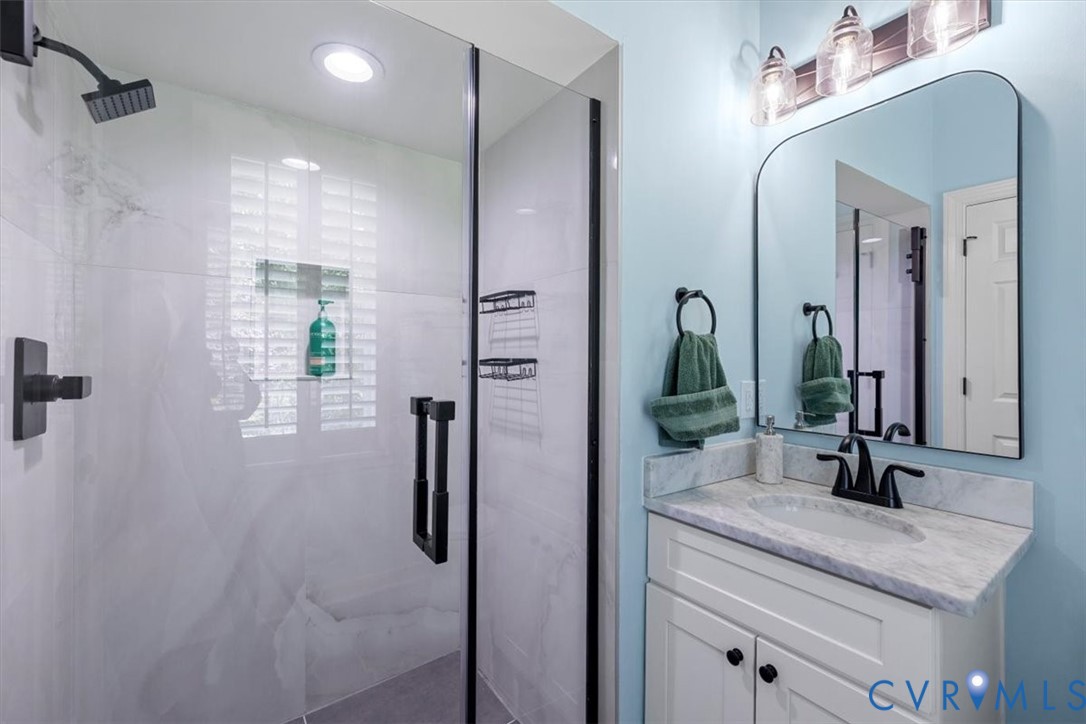 402 Rivers Bend Circle Chester, VA 23836 - Photo 36 of 80 a bathroom with a double vanity sink and a mirror