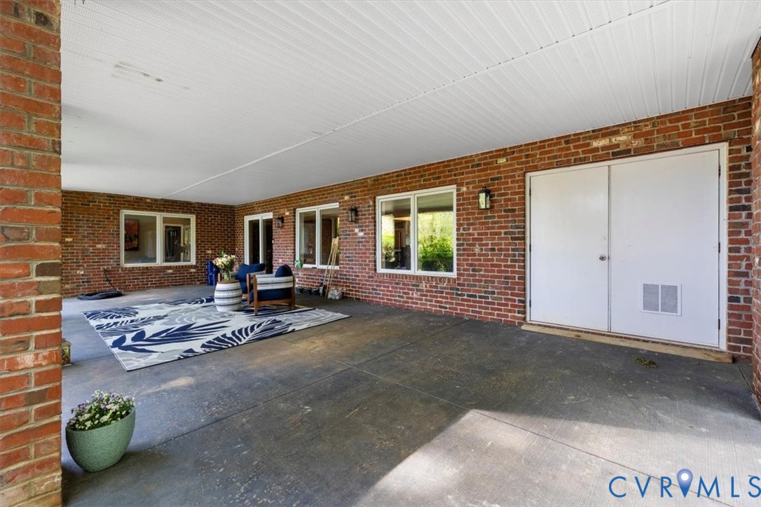 402 Rivers Bend Circle Chester, VA 23836 - Photo 72 of 80 a view of a livingroom with patio and a garden