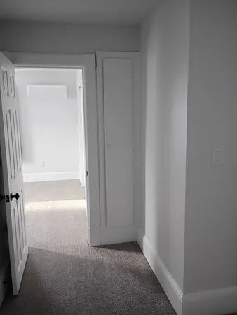 a kitchen with white cabinets and appliances