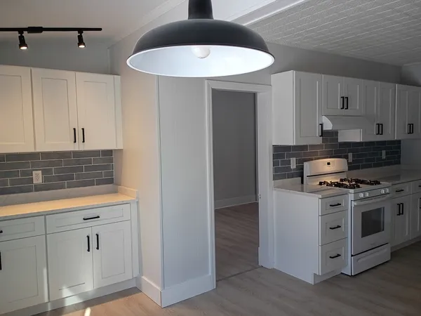 a kitchen with stainless steel appliances granite countertop a stove and a sink