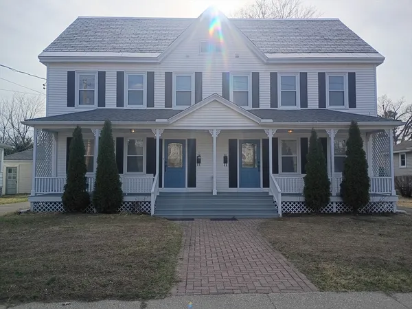 a front view of a house with a yard