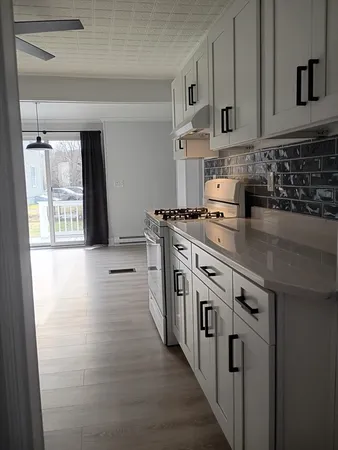 a kitchen with white cabinets and white appliances