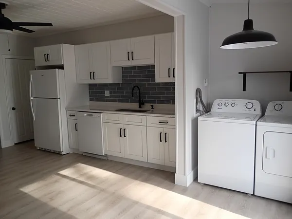 an empty room with wooden floor and a window