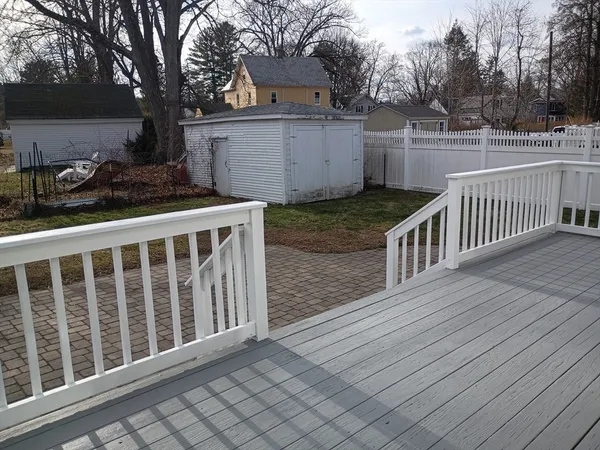 a view of a street with wooden fence