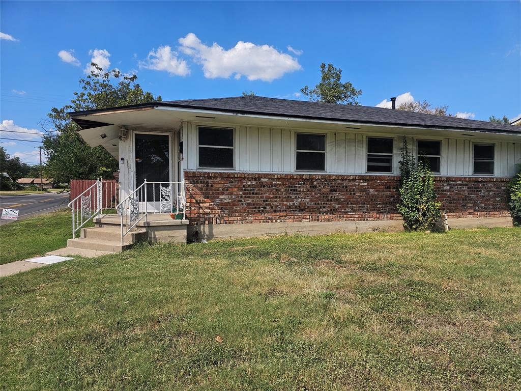 2701 MacArthur Drive Waco, TX 76708 - Photo 1 of 1 View of front of property featuring brick siding, board and batten siding, and a front yard