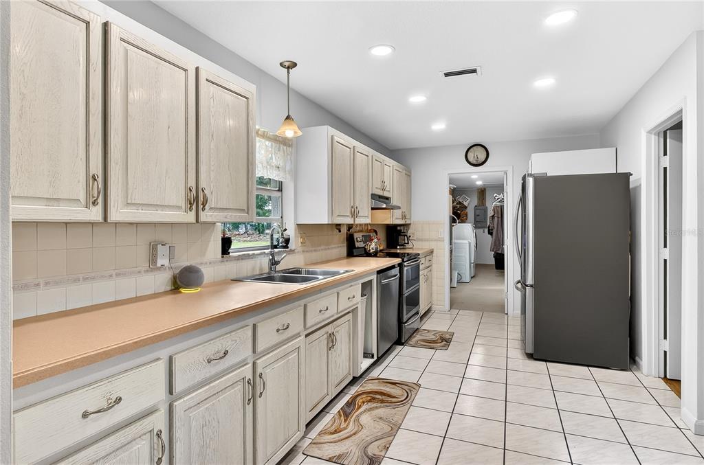 5304 Tillman Road Lakeland, FL 33810 - Photo 13 of 33 a large kitchen with stainless steel appliances a refrigerator sink and cabinets