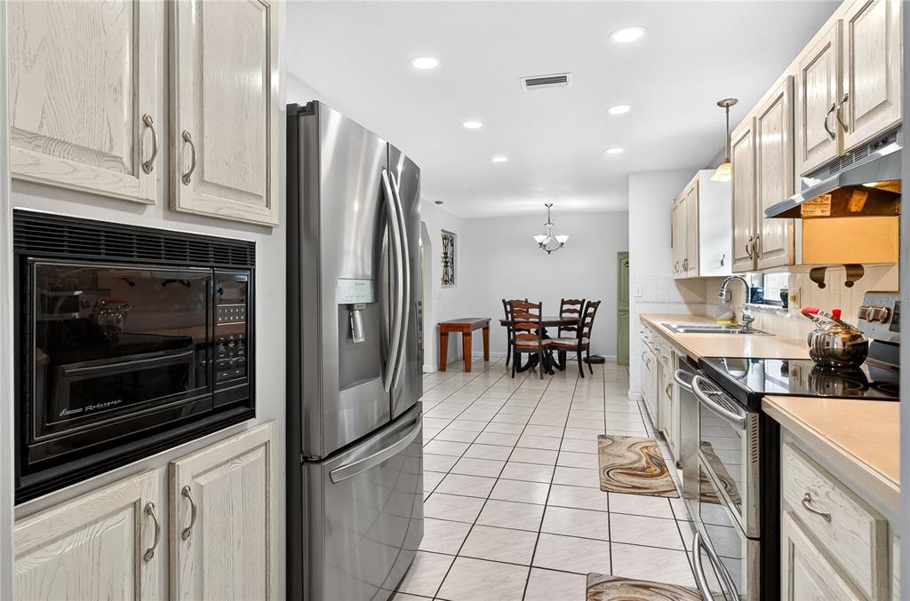 5304 Tillman Road Lakeland, FL 33810 - Photo 14 of 33 a kitchen with stainless steel appliances granite countertop a refrigerator a stove a sink and a microwave
