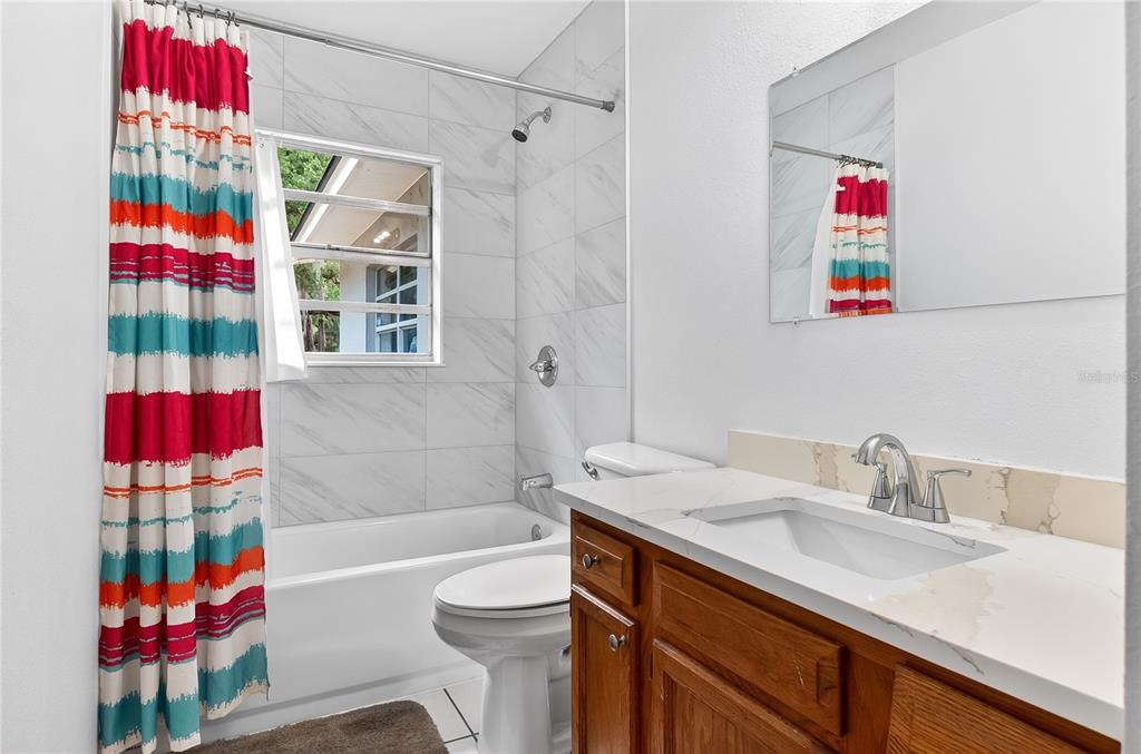 5304 Tillman Road Lakeland, FL 33810 - Photo 25 of 33 a bathroom with a sink toilet vanity and shower