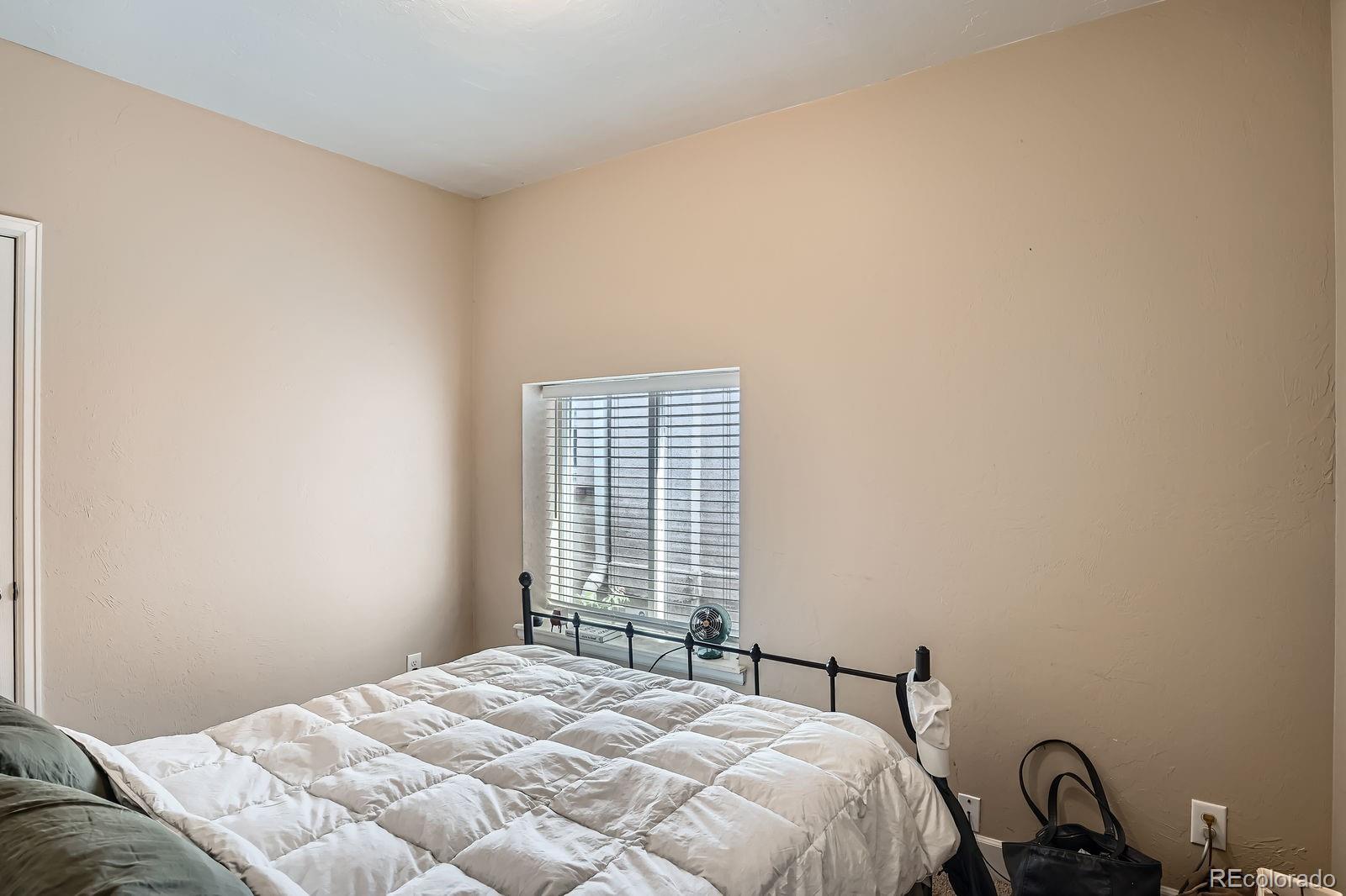 2838 Decatur Street Denver, CO 80211 - Photo 13 of 31 a bedroom with a bed and a window