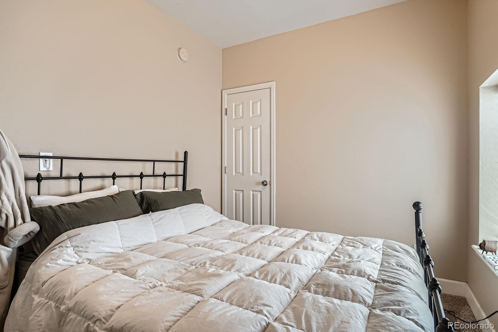 2838 Decatur Street Denver, CO 80211 - Photo 15 of 31 a bedroom with a bed and wooden floor