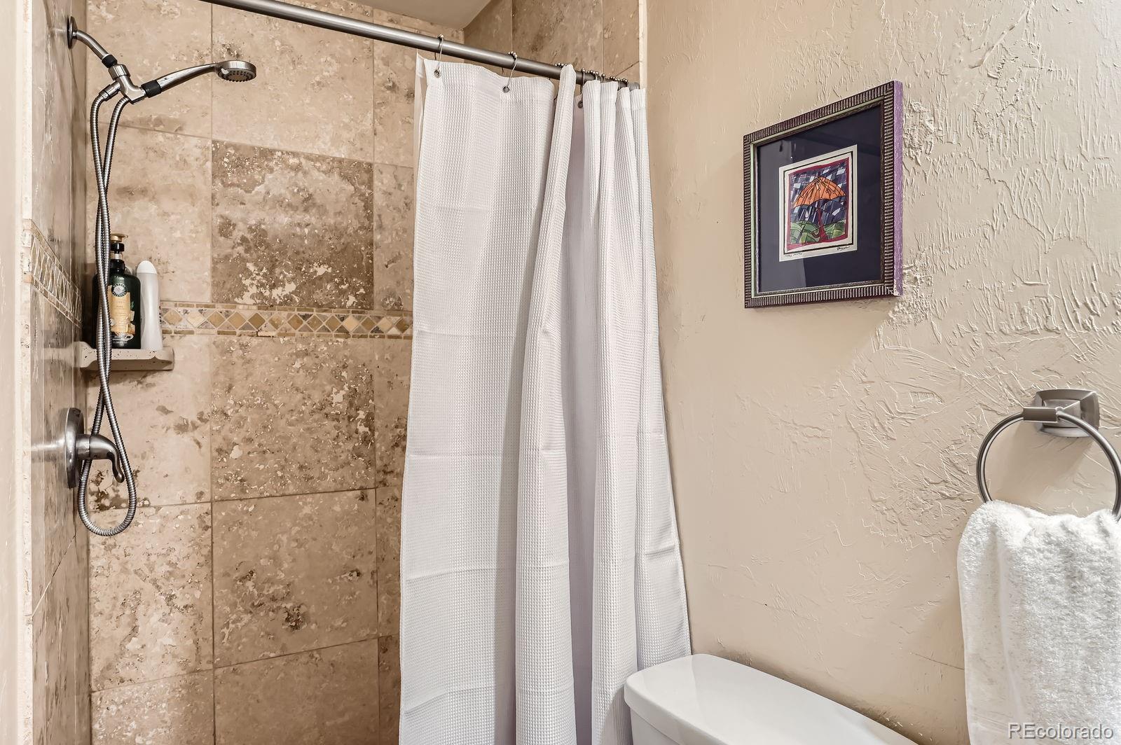 2838 Decatur Street Denver, CO 80211 - Photo 18 of 31 a bathroom with a shower toilet and sink