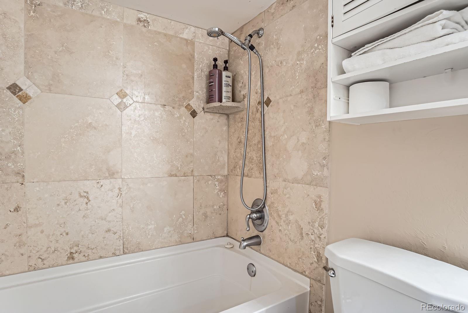 2838 Decatur Street Denver, CO 80211 - Photo 23 of 31 a bathroom with a bathtub and a toilet